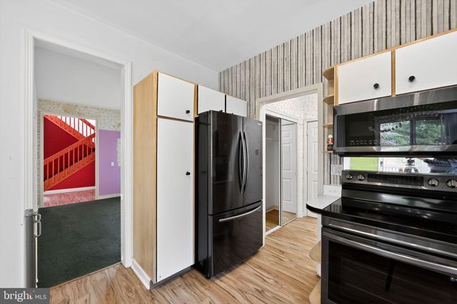 a kitchen with stainless steel appliances and refrigerator