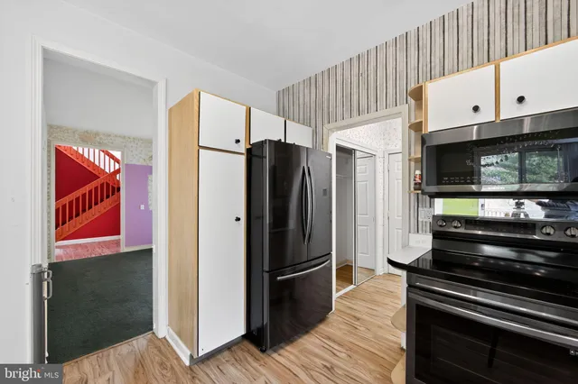 a kitchen with stainless steel appliances and refrigerator