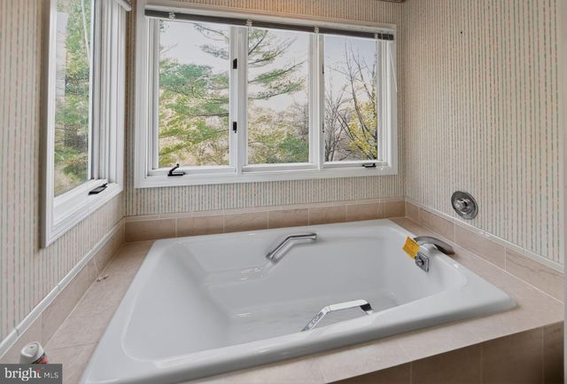 a bathroom with a tub and a shower