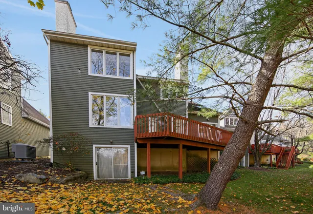 a view of a brick house with a large tree