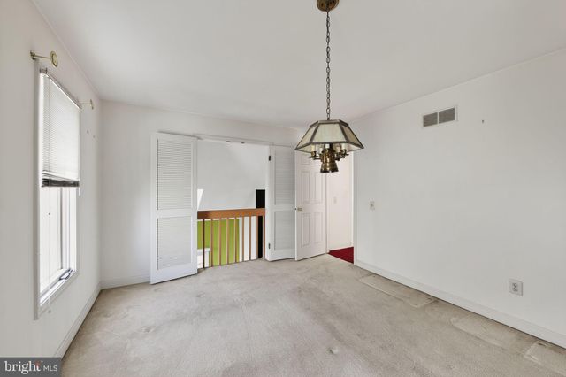 a view of a room with a window and furniture