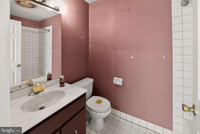 a bathroom with a sink a toilet and vanity