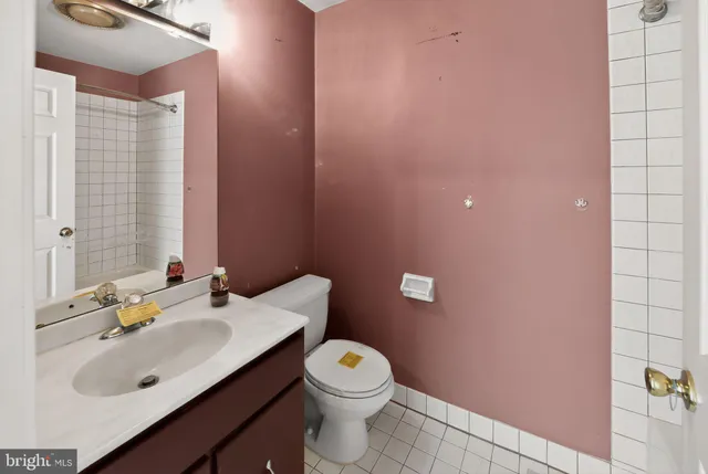 a bathroom with a sink a toilet and vanity