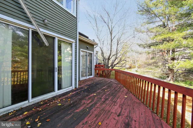 a view of a house with a wooden deck