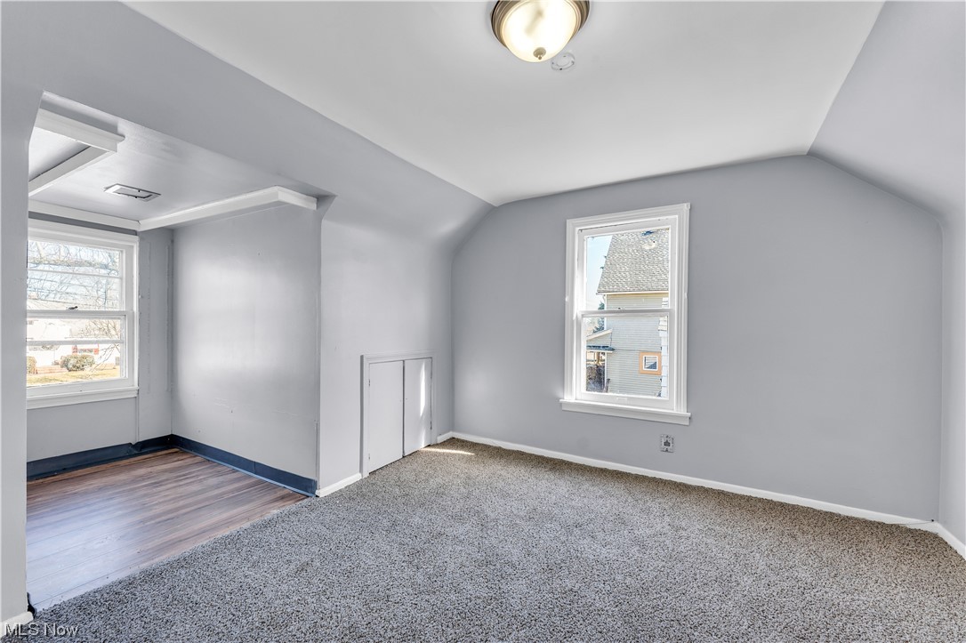 15400 Rockside Road Maple Heights, OH 44137 - Photo 19 of 31 Bonus room with dark colored carpet and lofted ceiling