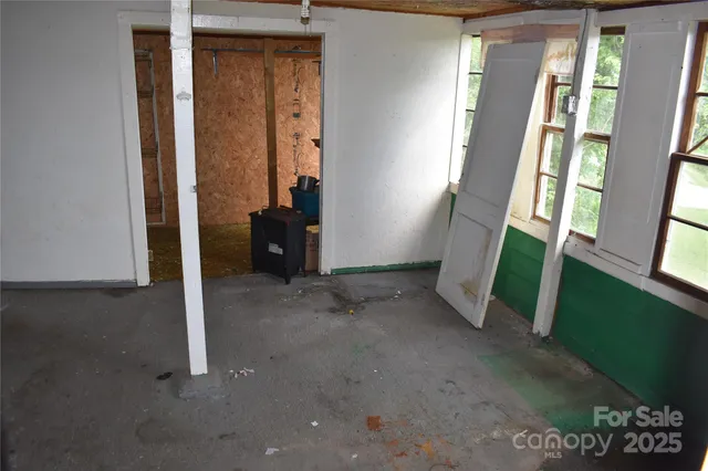 a backyard of a house with barbeque oven and table