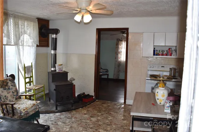 a living room with hard wood floor furniture and a chandelier