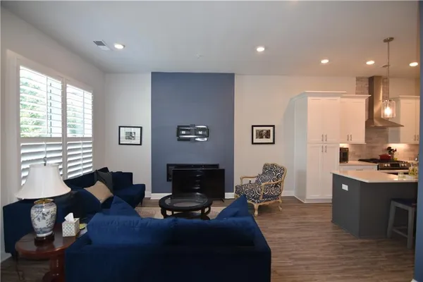 a living room with furniture a fireplace and a window