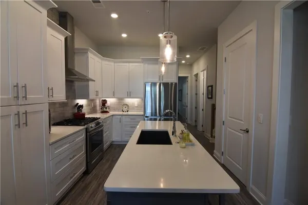a kitchen with refrigerator and cabinets