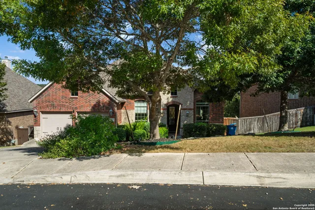 a front view of a house with a yard and a garage