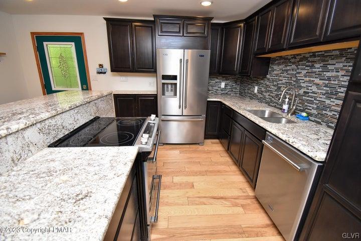 1239 Glenbrook Road Bartonsville, PA 18321 - Photo 11 of 32 a kitchen with granite countertop stainless steel appliances and wooden cabinets
