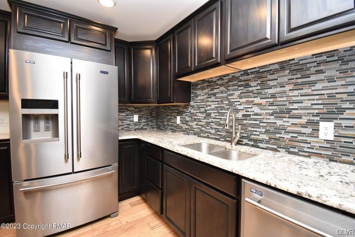 1239 Glenbrook Road Bartonsville, PA 18321 - Photo 13 of 32 a kitchen with granite countertop stainless steel appliances and refrigerator