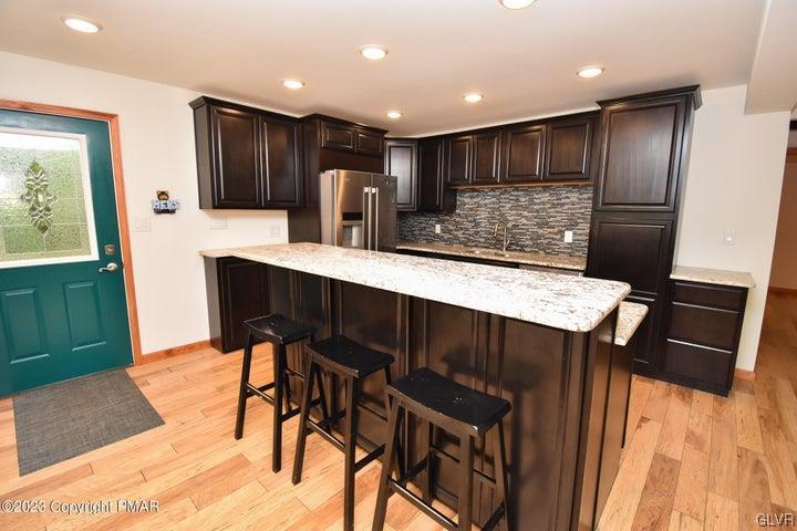 1239 Glenbrook Road Bartonsville, PA 18321 - Photo 14 of 32 a kitchen with stainless steel appliances kitchen island granite countertop a refrigerator a stove and a sink with wooden floor