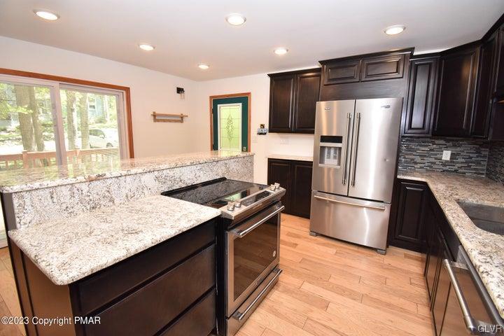 1239 Glenbrook Road Bartonsville, PA 18321 - Photo 15 of 32 a kitchen with stainless steel appliances granite countertop a refrigerator a sink and a stove