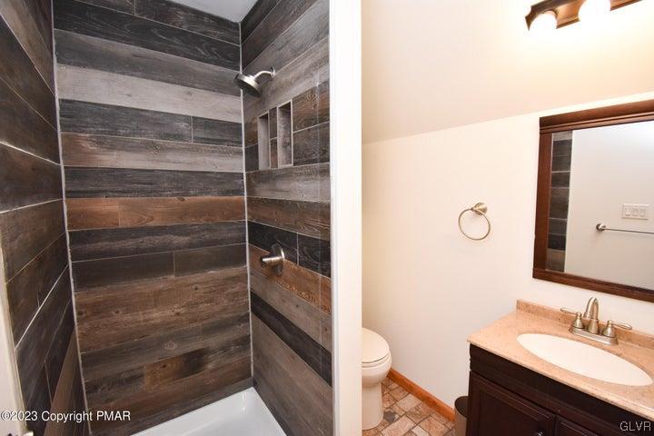 1239 Glenbrook Road Bartonsville, PA 18321 - Photo 29 of 32 a bathroom with a shower sink and toilet