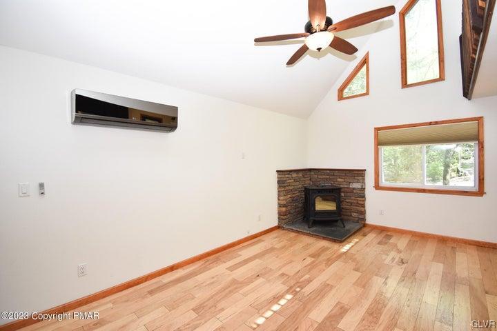 1239 Glenbrook Road Bartonsville, PA 18321 - Photo 7 of 32 a view of empty room with wooden floor and fireplace