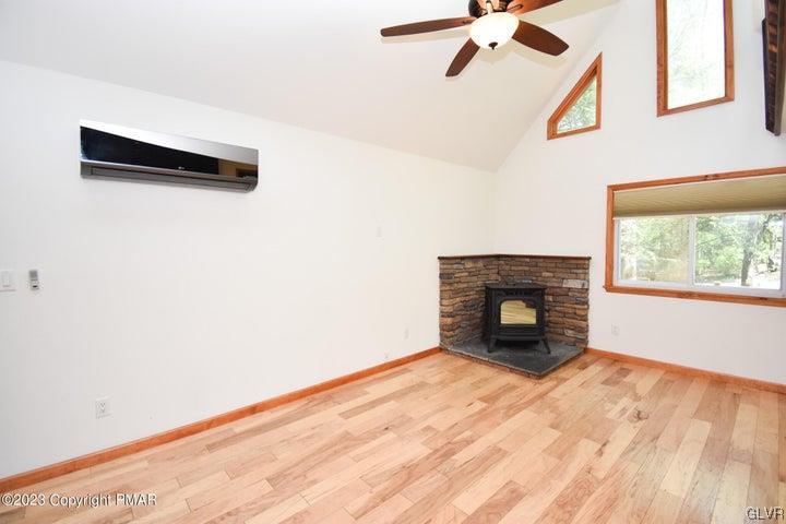 1239 Glenbrook Road Bartonsville, PA 18321 - Photo 10 of 32 a view of empty room with a fireplace and wooden floor