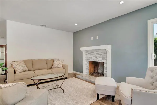 a living room with furniture and a fireplace