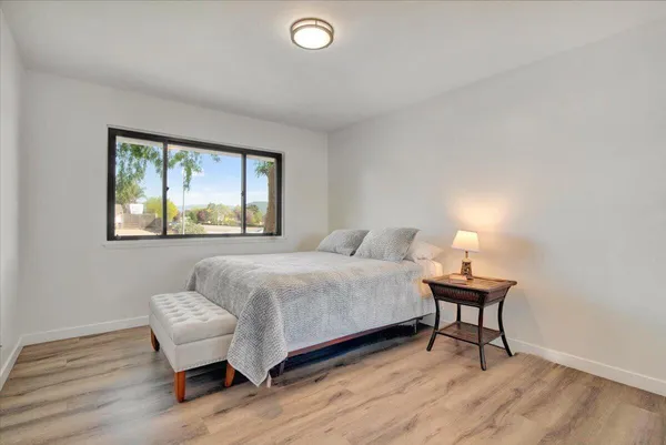 a bedroom with a bed and a lamp on table