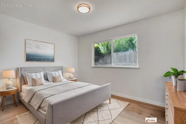 a bedroom with a bed and a potted plant