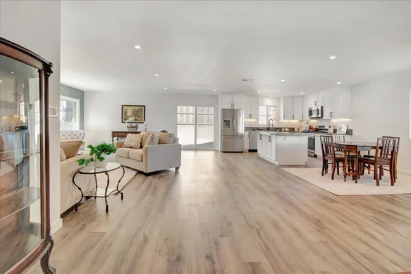 a living room with furniture and a wooden floor