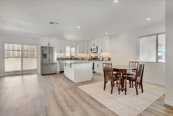 a view of a dining room with furniture and wooden floor