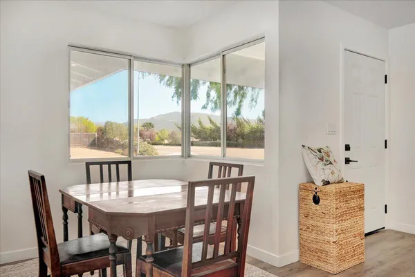 a view of a dining room with furniture window and wooden floor