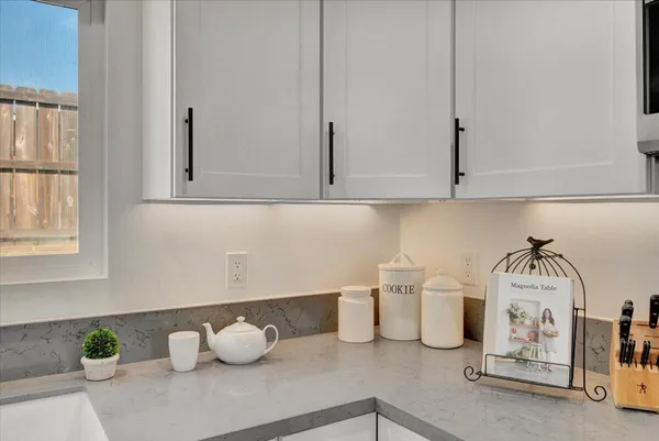 a kitchen with a sink and white cabinets