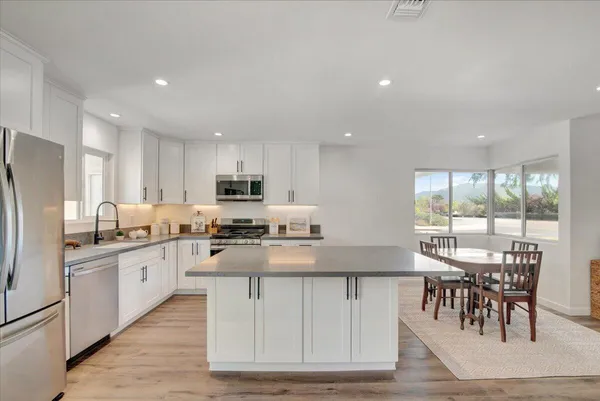 a large kitchen with kitchen island a large island in the center