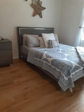 a bedroom with a bed and window