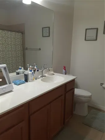 a bathroom with a sink toilet and a mirror