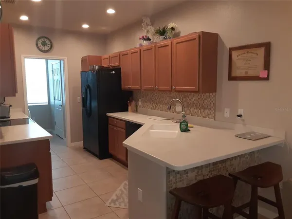 a kitchen with a sink a refrigerator and a stove