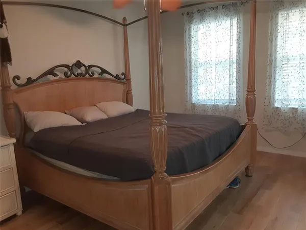 a bed sitting in a bedroom next to a window