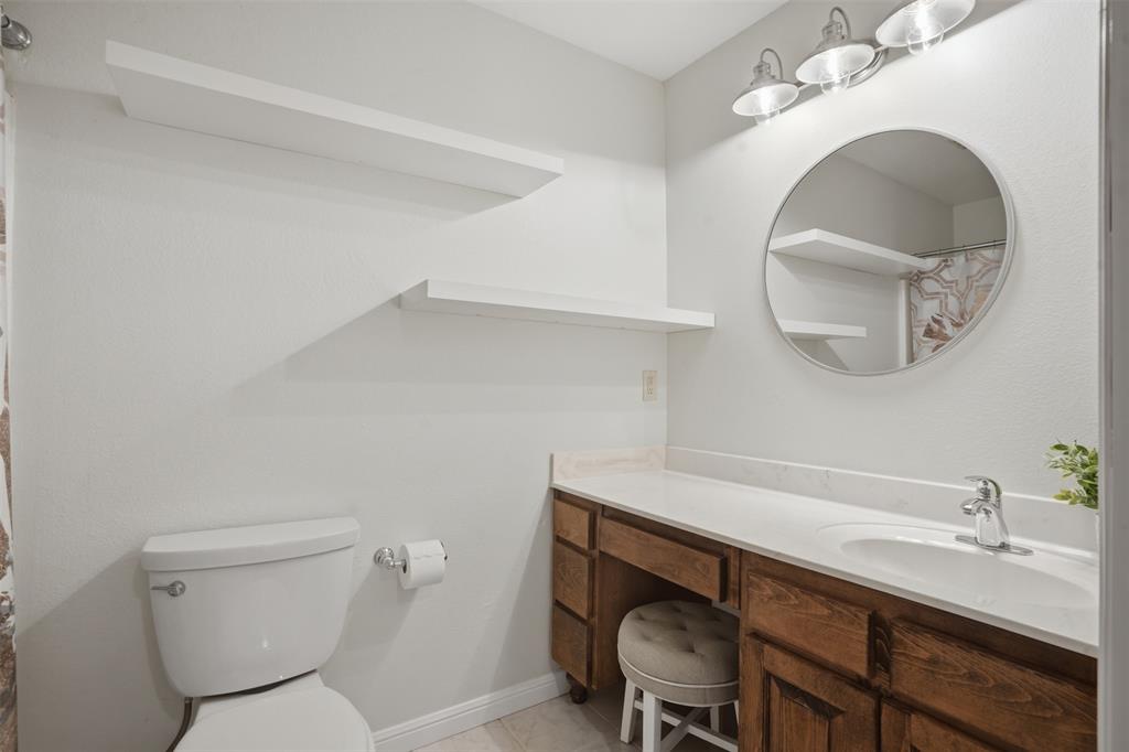 9651 Yellow Rose Lane Pilot Point, TX 76258 - Photo 30 of 38 a bathroom with a toilet a sink and mirror