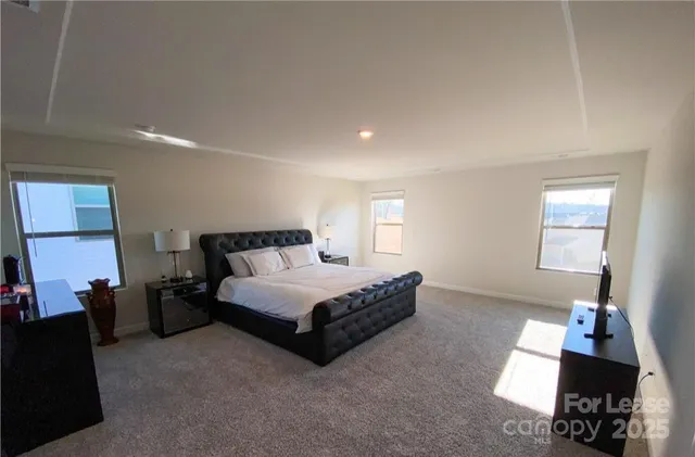 a spacious bedroom with a bed and a couch