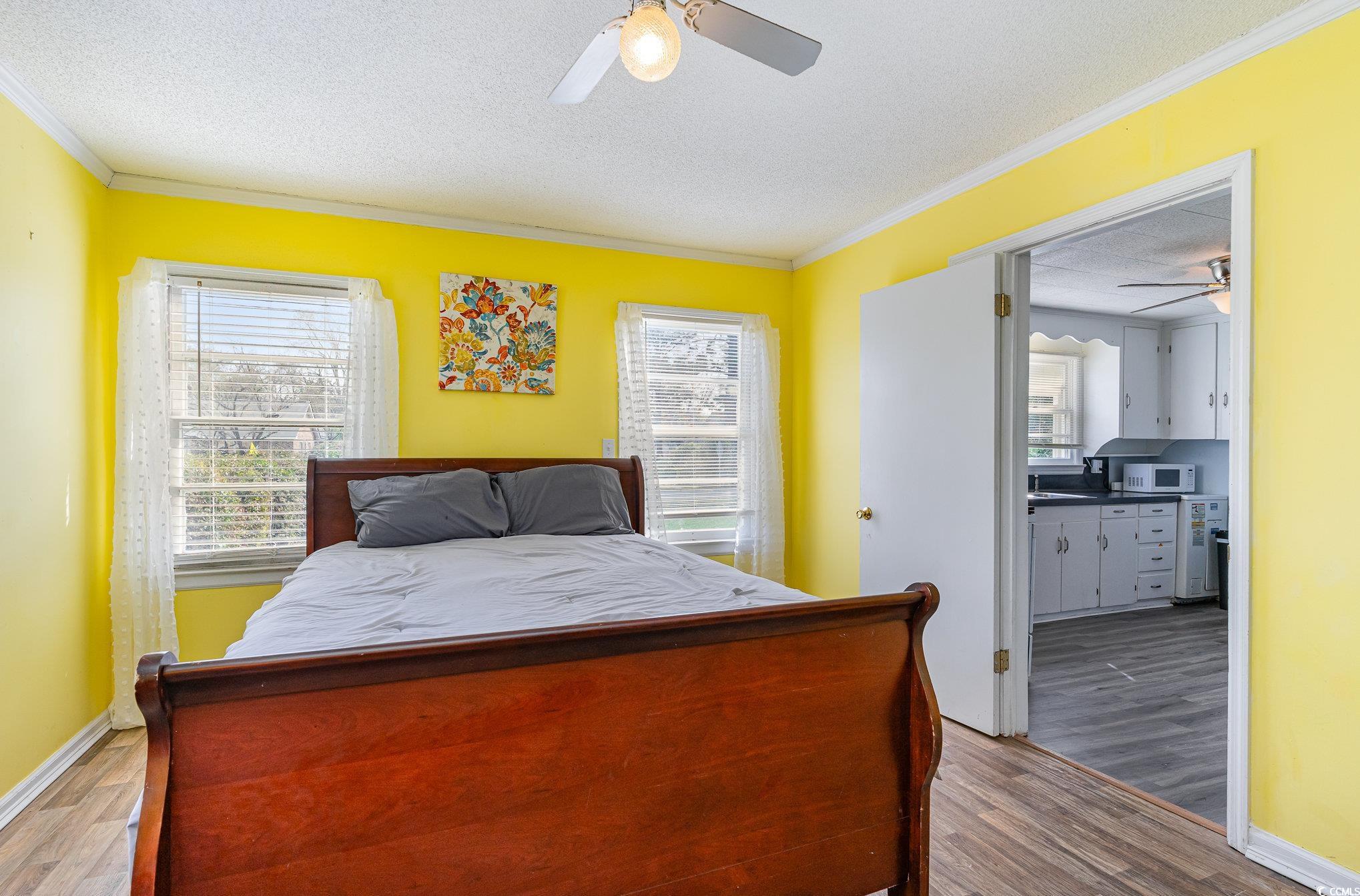 606 Britt Street Georgetown, SC 29440 - Photo 12 of 28 Bedroom with wood finished floors, a textured ceil