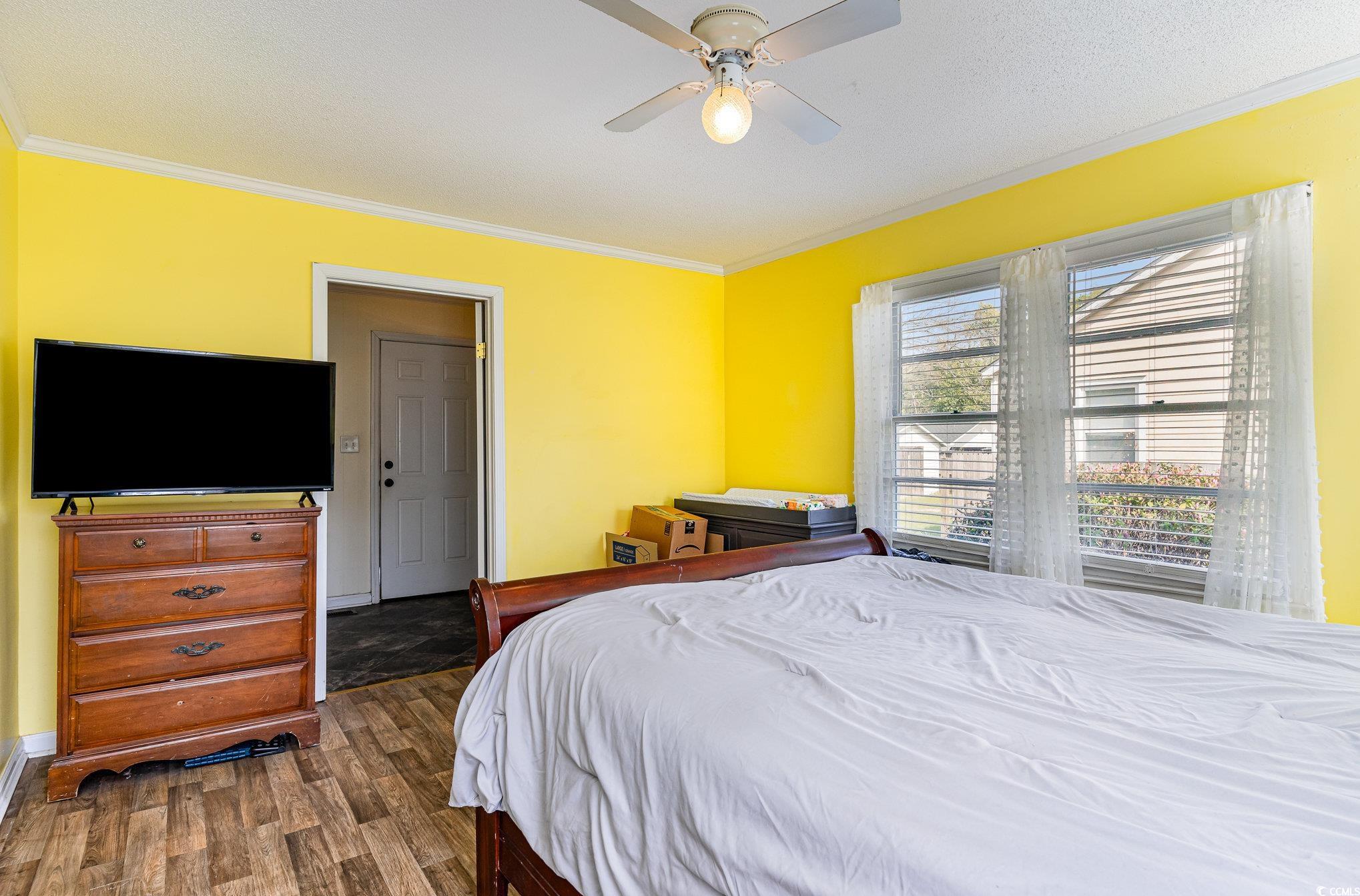 606 Britt Street Georgetown, SC 29440 - Photo 13 of 28 Bedroom with ceiling fan, baseboards, crown moldin
