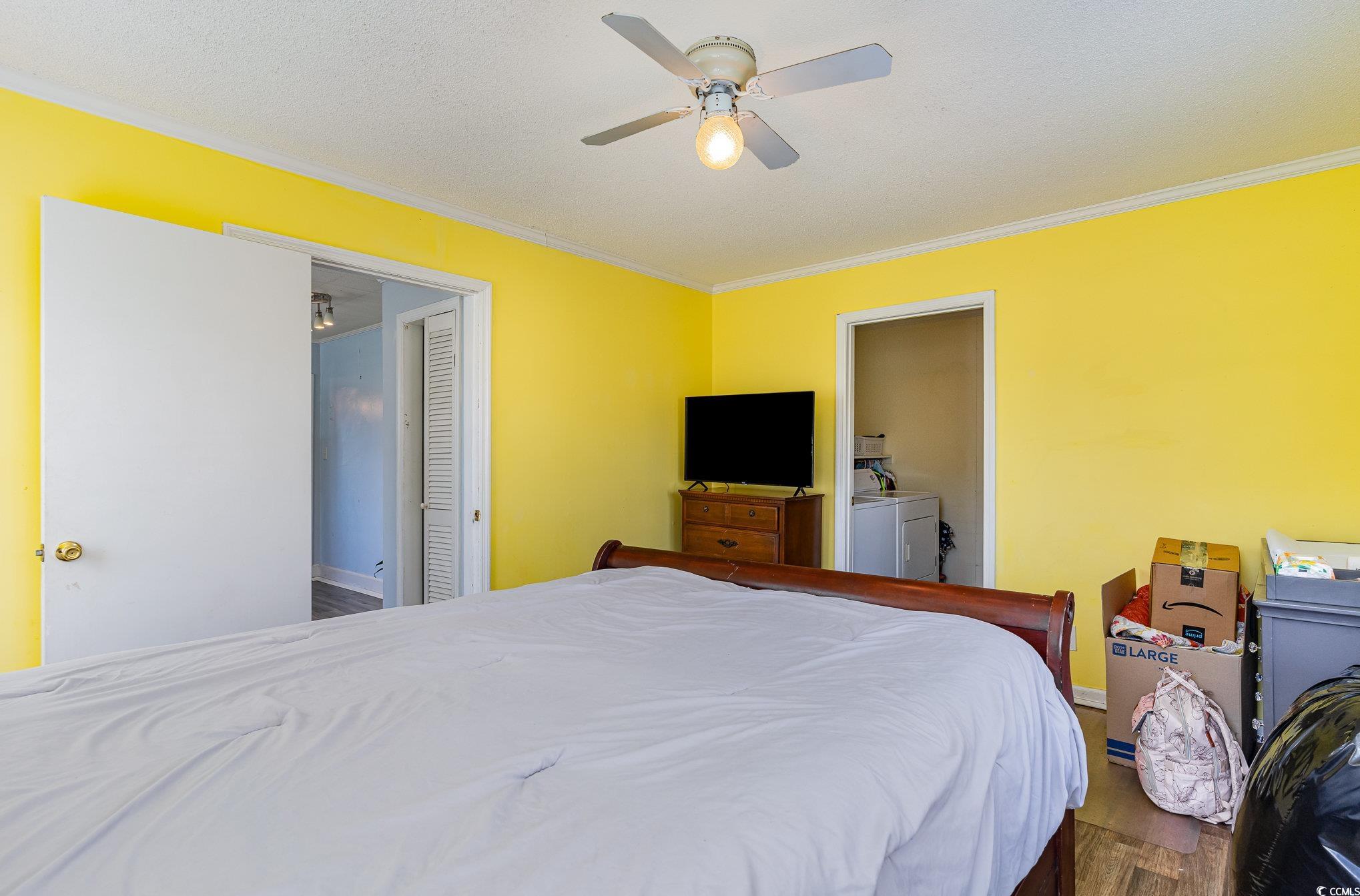 606 Britt Street Georgetown, SC 29440 - Photo 14 of 28 Bedroom with ornamental molding, washer and dryer,