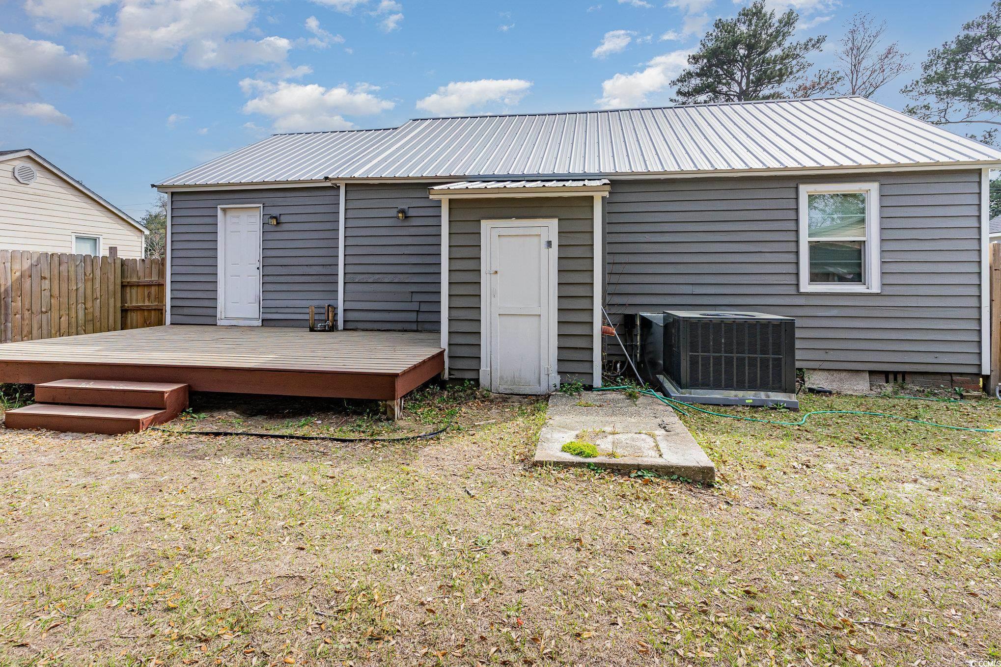 606 Britt Street Georgetown, SC 29440 - Photo 24 of 28 Back of house featuring fence, cooling unit, a yar