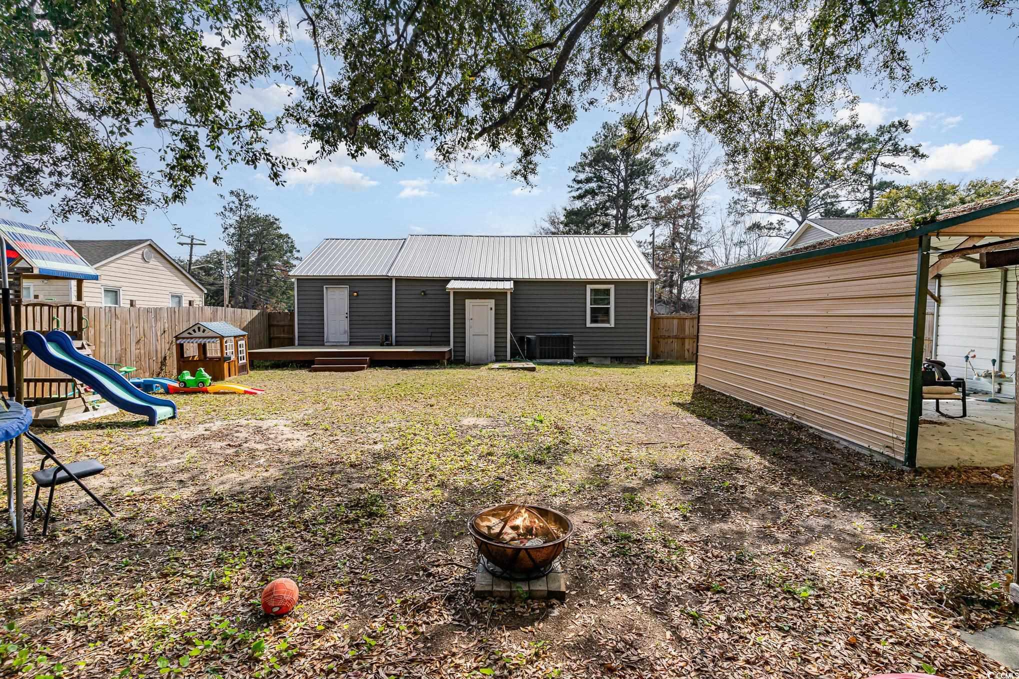 606 Britt Street Georgetown, SC 29440 - Photo 25 of 28 Rear view of property with metal roof, a fire pit,