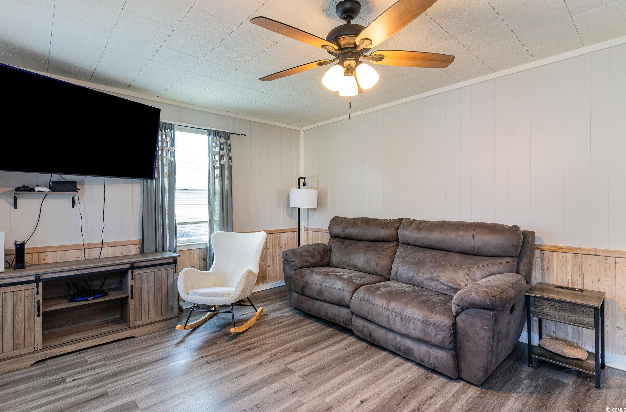 606 Britt Street Georgetown, SC 29440 - Photo 4 of 28 Living room with wainscoting, crown molding, light