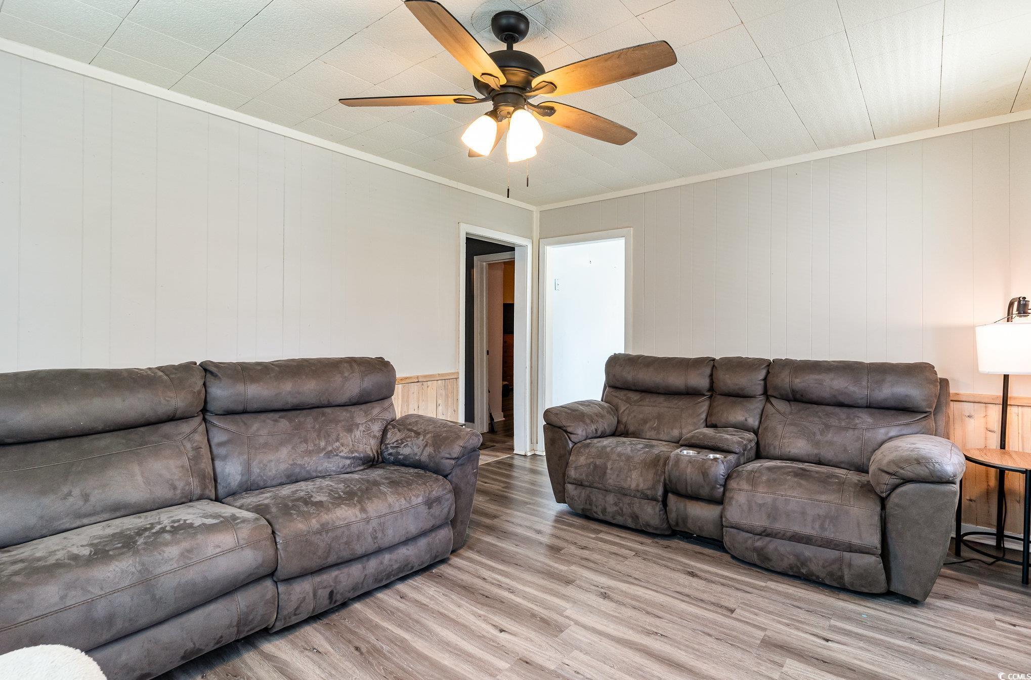 606 Britt Street Georgetown, SC 29440 - Photo 6 of 28 Living area featuring crown molding, ceiling fan,