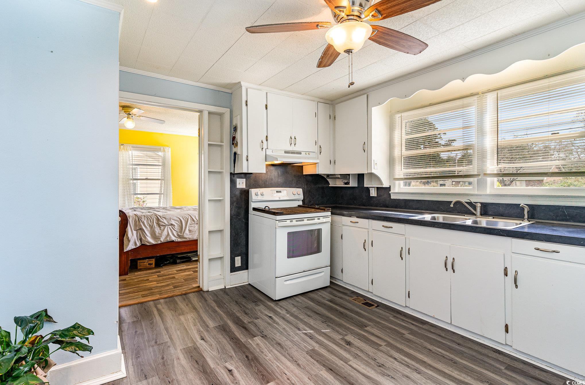 606 Britt Street Georgetown, SC 29440 - Photo 8 of 28 Kitchen with dark wood finished floors, ceiling fa