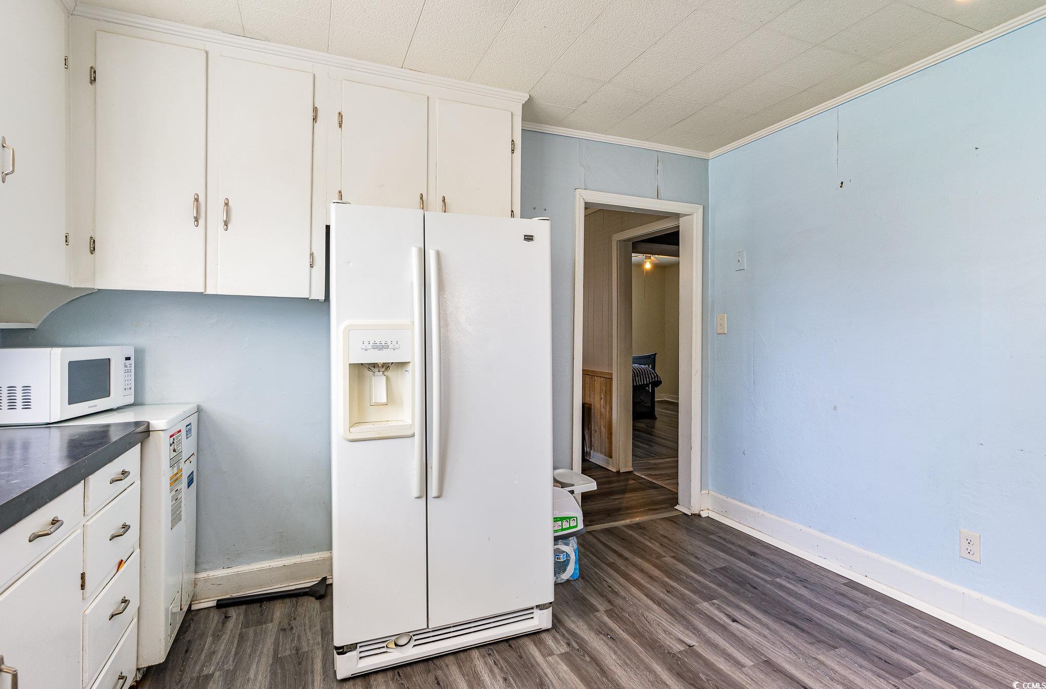 606 Britt Street Georgetown, SC 29440 - Photo 9 of 28 Kitchen with white cabinets, white appliances, orn