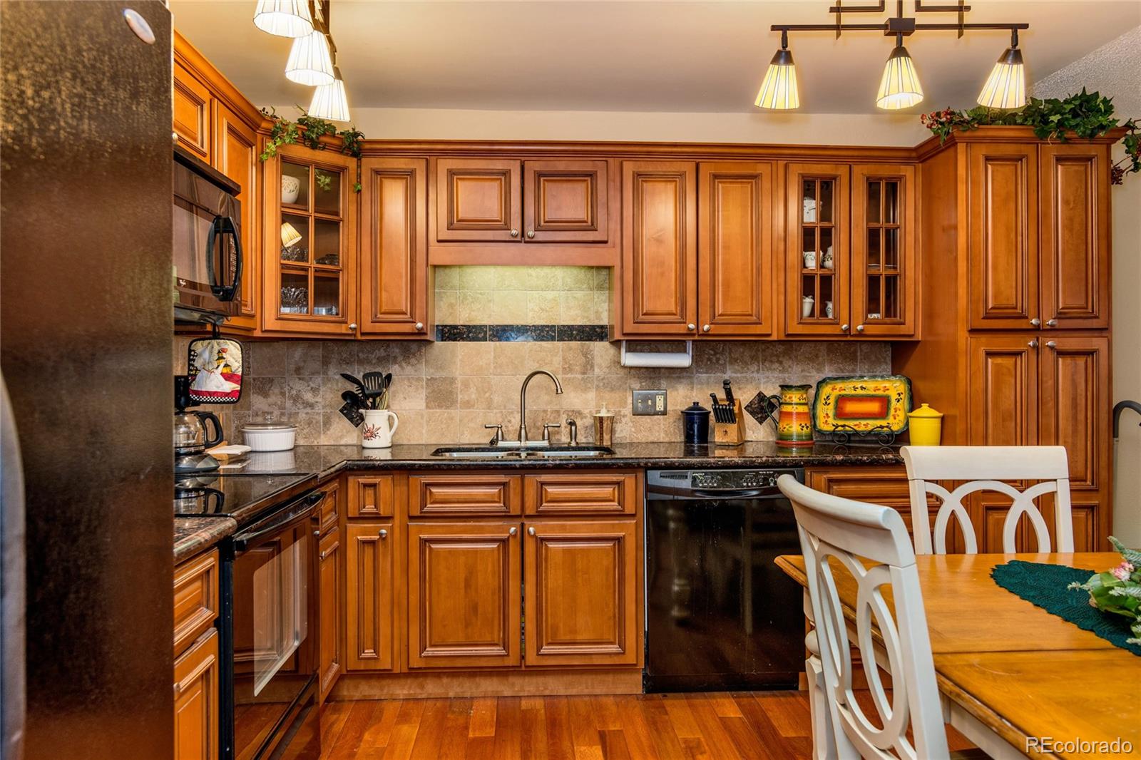 a kitchen with stainless steel appliances granite countertop a stove and cabinets