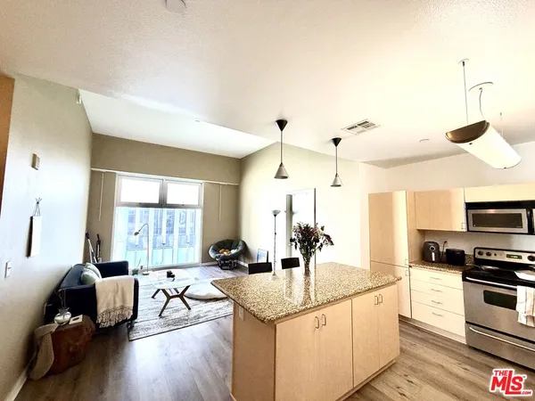 a kitchen with sink refrigerator and stove