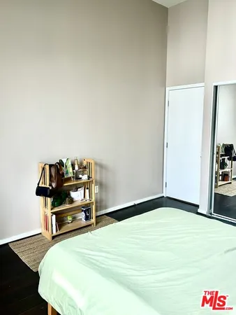 a bedroom with a bed and a book shelf