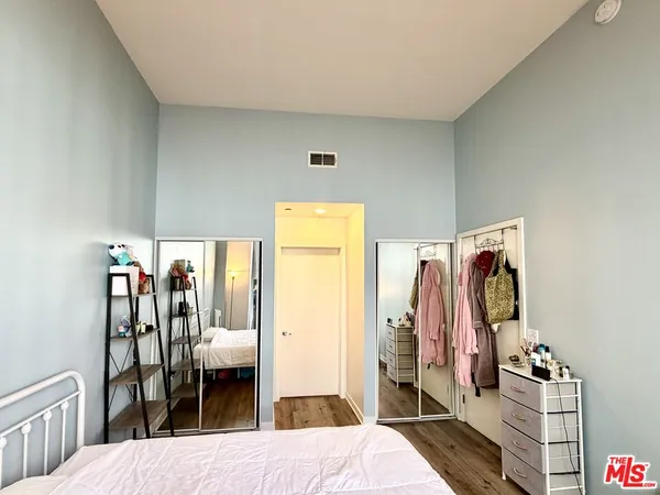 a bedroom with a bed and walk in closet