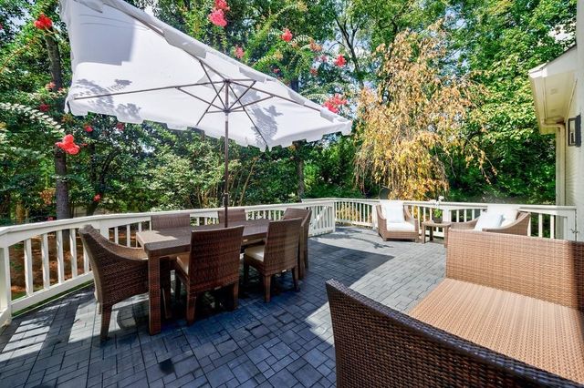 a kitchen with stainless steel appliances granite countertop a sink a stove a refrigerator and island with wooden floor