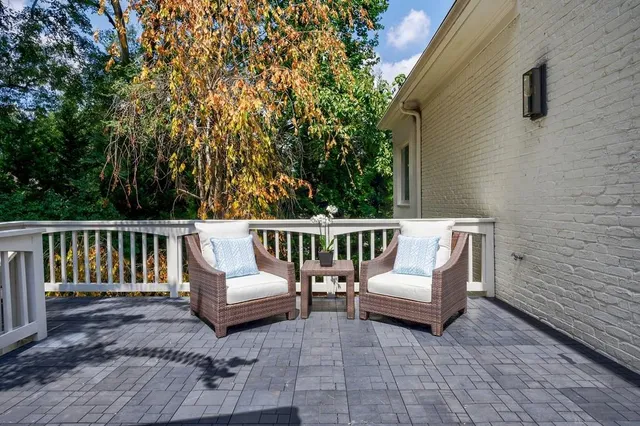 a view of a dining room with furniture large windows and wooden floor
